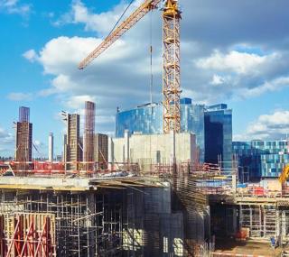 city skyline with construction and cranes in view